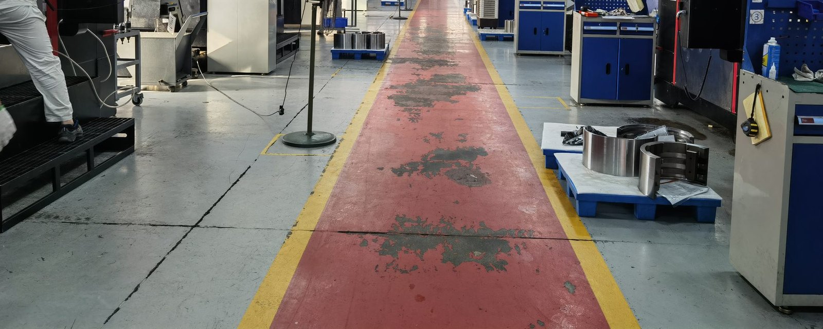 CNC machining workshop floor with rows of machining centers