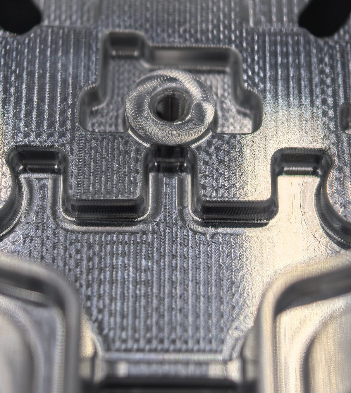 Close-up of a 5-axis CNC milled aluminum part with fine tool paths