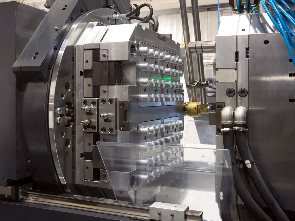 Injection mold tooling mounted in a molding machine